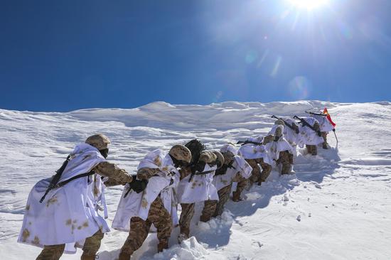 Soldiers patrol on snow-capped plateau