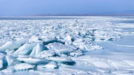 Blue ice chunks stack up along Qinghai Lake