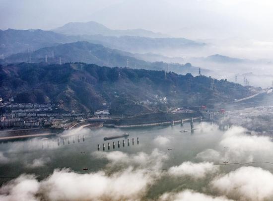 Three Gorges Dam enveloped in clouds after rain