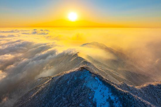 Sunrise scenery of clouds-shrouded snowy mountain in Hangzhou